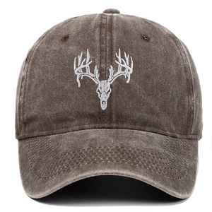 Detail of deer skull embroidery on a vintage washed brown cotton baseball cap