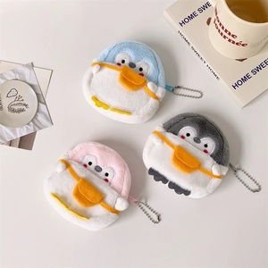 Close-up of plush penguin coin purses in blue, pink, and grey with silver bead chains
