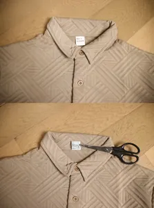 Detail shot of khaki textured jacquard fabric and neck label on casual men shirt