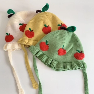 Cute apple-themed baby knit beanies in cream, yellow, and green with red embroidery