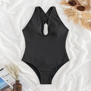Flat lay of black one-piece swimsuit with halter neck and cutout detailing