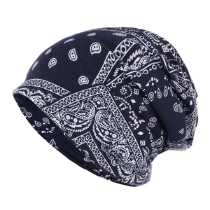 Navy blue slouchy beanie with white paisley pattern made of soft cotton fabric