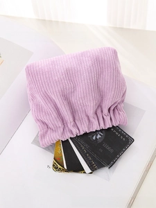 Detail of light purple corduroy mini pouch showing elastic closure and card storage