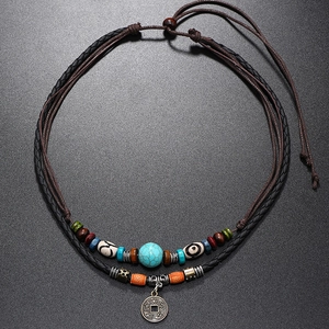 Close-up of double-layer turquoise beaded necklace with retro copper coin pendant