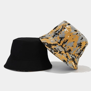 Detail of reversible camouflage and solid black bucket hat with high-quality twill fabric
