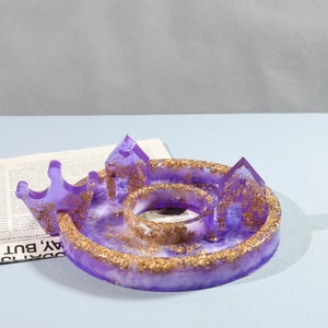 Detail of purple resin angel house mold with gold foil flakes and glossy finish