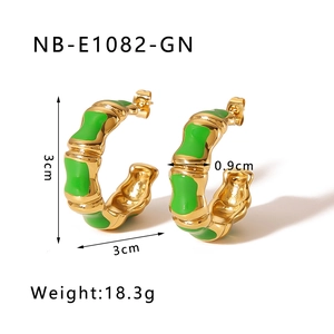 Detail showing 3cm gold C-shaped earrings with green enamel bamboo design and 18.3g weight