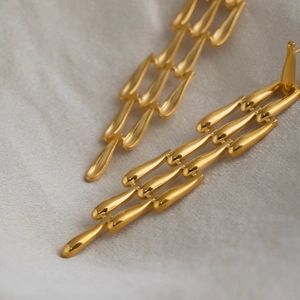 Boucles d'oreilles pendantes dorées avec maillons tissés en acier inoxydable poli