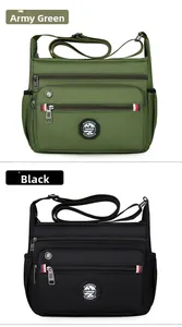 Detail view of multi-compartment nylon messenger bags in military green and black colors