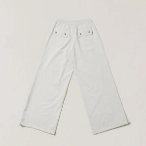 Detail of off-white wide-leg cargo pants with rear pockets and adjustable drawstring hem