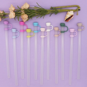 Detailed view of twelve colorful 10mm silicone straw covers arranged on a purple background
