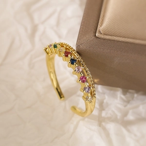 Adjustable gold-plated copper ring with colorful zircons in a champagne jewelry box