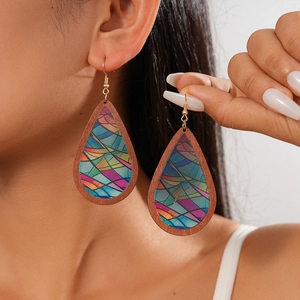 Detail of bohemian wood teardrop earrings with colorful geometric acrylic patterns