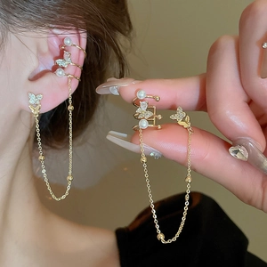 Elegant gold-plated butterfly earring with zircon and pearl tassels on a model