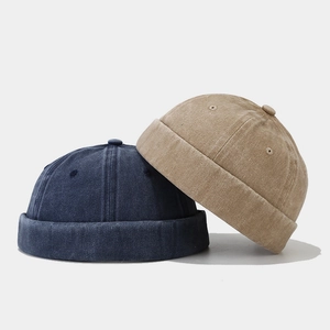 Vintage washed docker caps in navy blue and khaki with minimalist stitch detailing