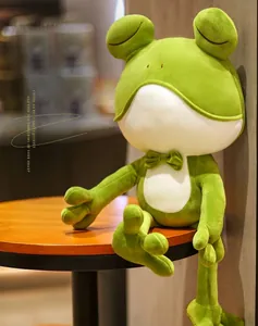 Close-up of a cute green frog plush toy with a bow tie and soft fabric texture