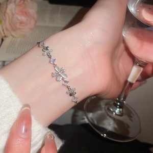Elegant silver bracelet with zircon and cat eye stone flower charms on wrist