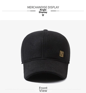 Close-up of black wool baseball cap with a square gold metal logo and premium texture
