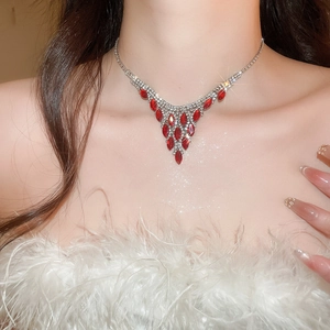 Detail of red marquise gem necklace with silver fringe and crystals on model's neck