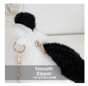 Close-up of smooth gold metal zipper and chain strap on plush panda shoulder bag