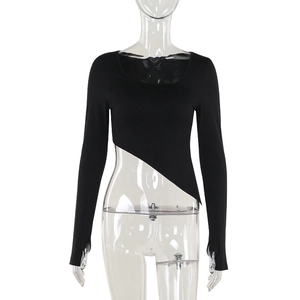 Detailed view of the asymmetrical slanted hem on a black slim-fit long sleeve top