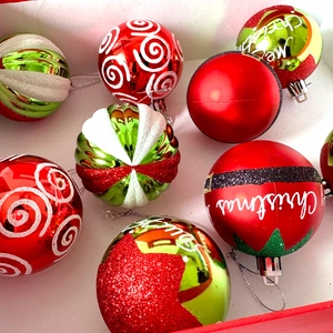 Detailed close-up of 6cm red and green Christmas balls with glitter and Santa designs