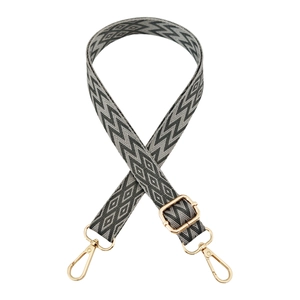 Close-up of 2.5cm embroidered shoulder strap with grey geometric pattern and gold buckles