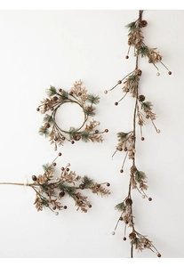 Detailed view of Christmas wreath and pine garland with golden pinecones and green needles
