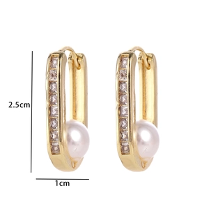 Detailed view of U-shaped gold earrings with zircon stones and pearls showing dimensions
