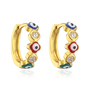 Macro shot of gold-plated evil eye hoop earrings with colorful enamel and zircon stones