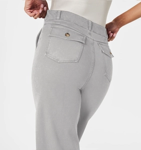 Detail of grey cropped wide-leg jeans featuring a buttoned flap back pocket and twill fabric