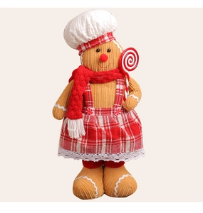 Detailed shot of Christmas gingerbread man doll with chef hat and striped plush texture