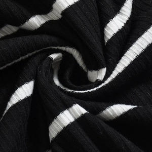 Macro view of black and white striped knitted fabric with ribbed texture and soft drape