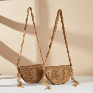 Handmade woven straw crossbody bag with decorative tassels for casual summer beach vacation