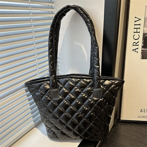 Chic black quilted tote bag for women with glossy finish and spacious puffy design