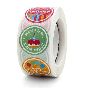 Detailed close-up of colorful round birthday stickers with cake and balloon patterns