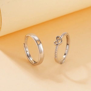 Macro shot of S925 sterling silver couple rings showing the heart-shaped cutout detail