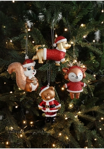 Detailed view of red and gold glitter animal Christmas ornaments on a festive tree