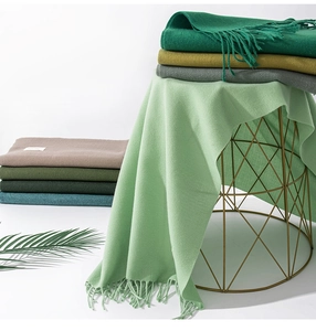 Close-up of soft cashmere-feel scarves with fringe detail in multiple trendy colors