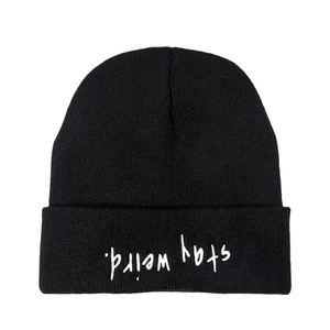 Minimalist black autumn knit beanie featuring unique inverted 'stay weird.' white embroidery