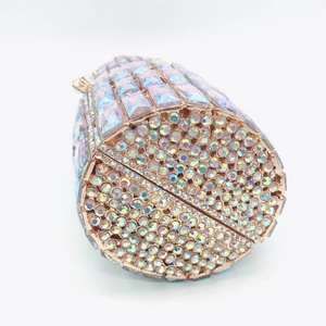 Macro shot of luxury gold-tone lipstick clutch showing intricate crystal embellishments