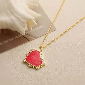 Golden necklace with marble textured red heart pendant and cubic zirconia details