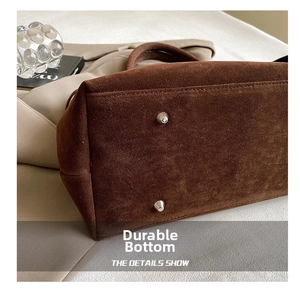 Detail shot of the vintage suede tote bag bottom with protective metal rivets