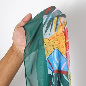 Detail of sheer mesh beach skirt showing vibrant leopard and geometric floral prints