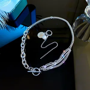 Detail of OT buckle necklace with crystal chains, pearls and round relief pendant