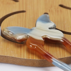 Macro view of gradient butterfly hair pin with resin texture and refined details