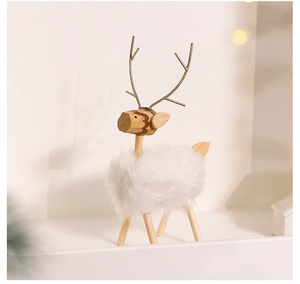 Detail of Nordic wooden elk figurine with white plush fur and warm aesthetic lighting