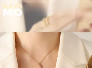 Model wearing gold star and moon pendant necklace with black enamel inlay and 18k plating