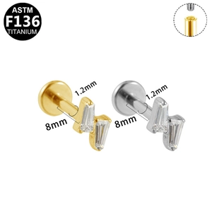 Detail of G23 titanium lightning labret studs in gold and silver with internal threading