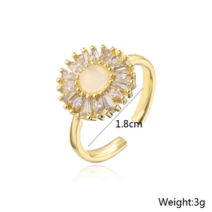 Detail shot of 18K gold plated sunflower ring with white opal and cubic zirconia inlay